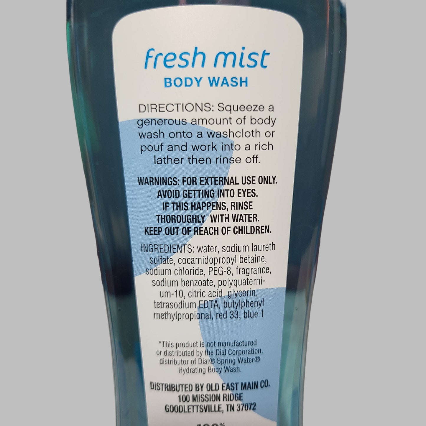 Body wash bottle with label on a neutral background